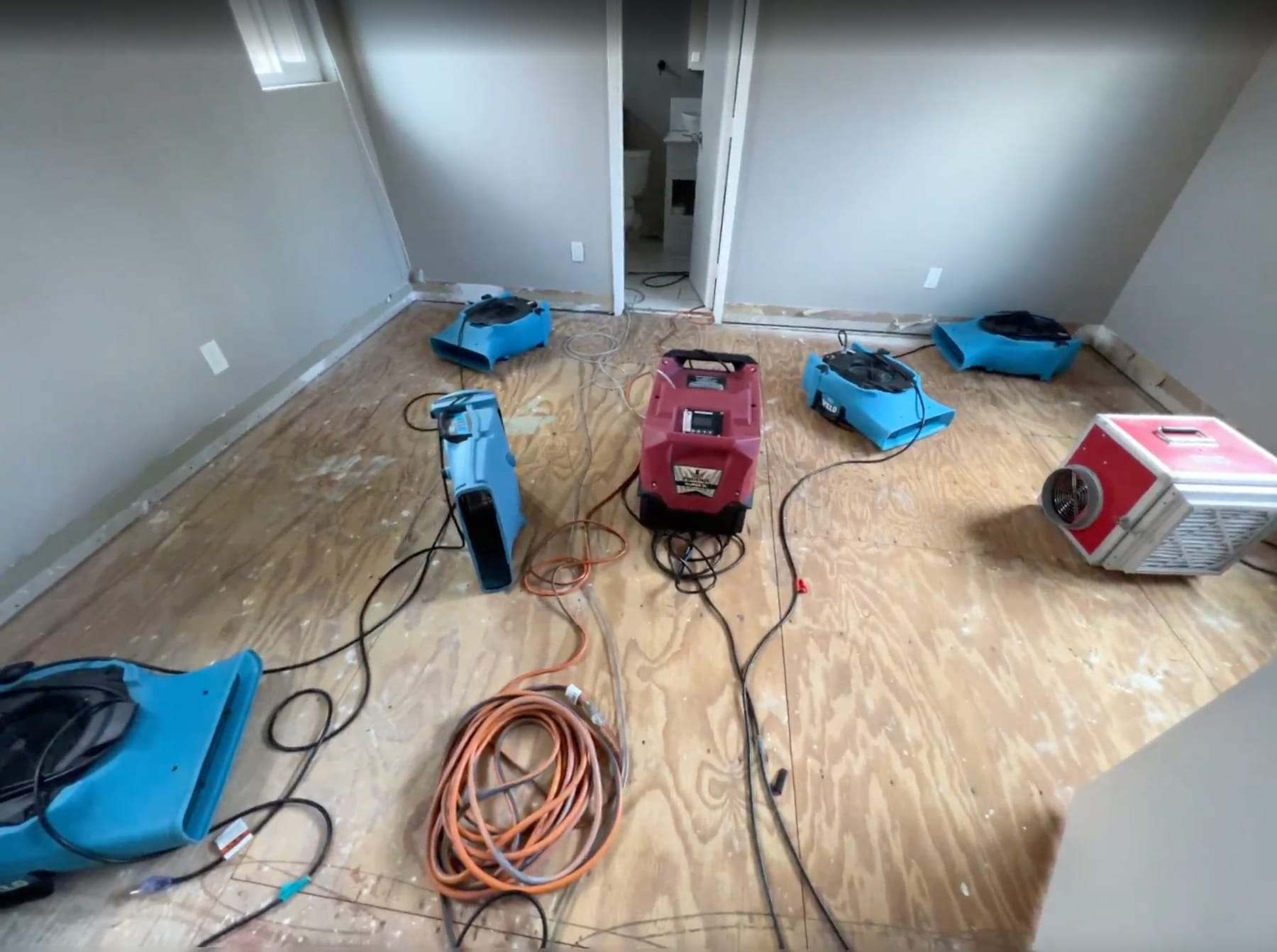 Bedroom subfloor drying with air movers and dehumidifiers